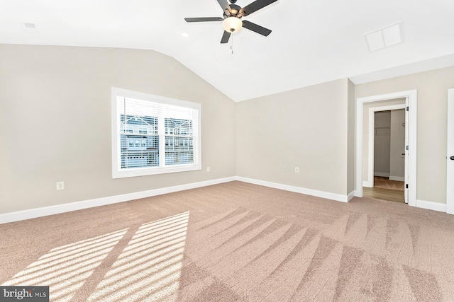 unfurnished room with ceiling fan, vaulted ceiling, and carpet