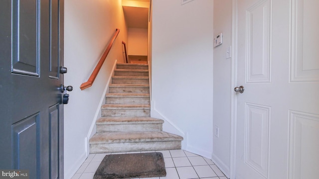 stairway with tile patterned flooring