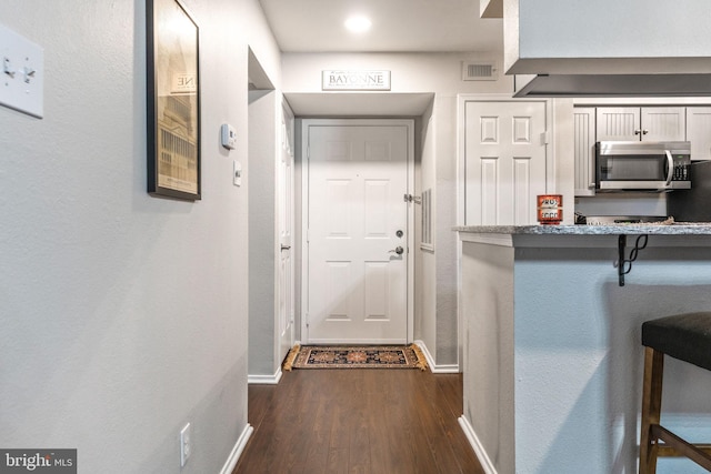 doorway with dark hardwood / wood-style flooring