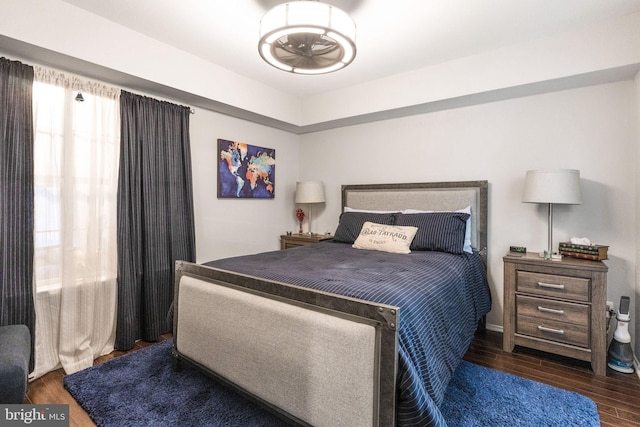 bedroom with dark hardwood / wood-style flooring