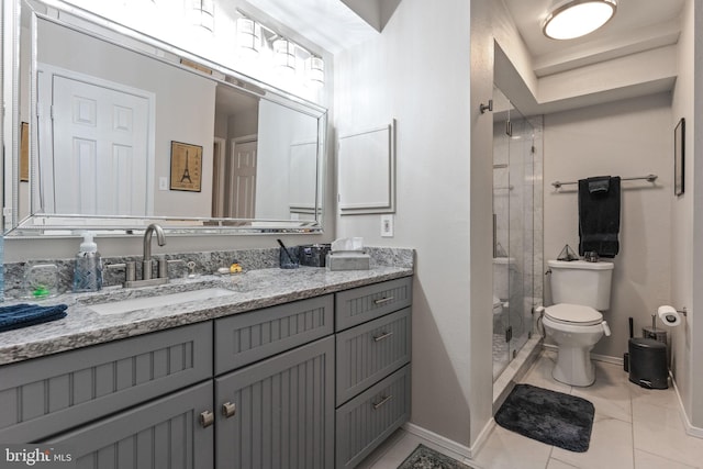 bathroom with vanity, toilet, and tiled shower