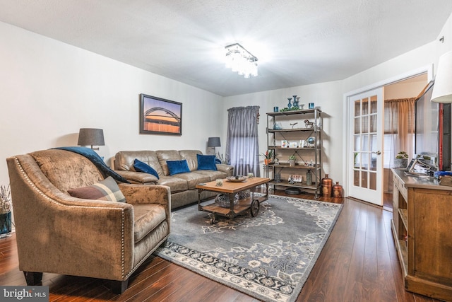 living room with dark hardwood / wood-style floors and a textured ceiling