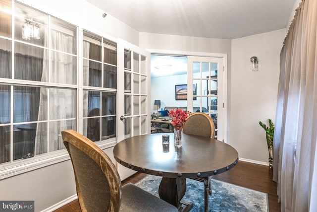 dining area with wood-type flooring and french doors