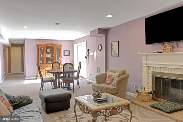 living room with light colored carpet and a fireplace