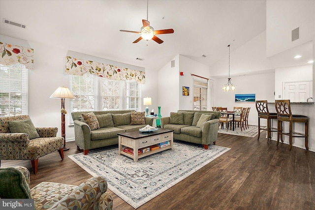 living room featuring ceiling fan with notable chandelier, high vaulted ceiling, and dark hardwood / wood-style floors