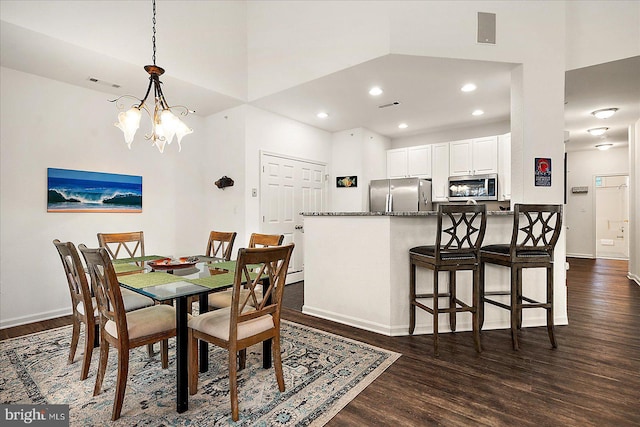 dining room featuring dark hardwood / wood-style flooring and a chandelier