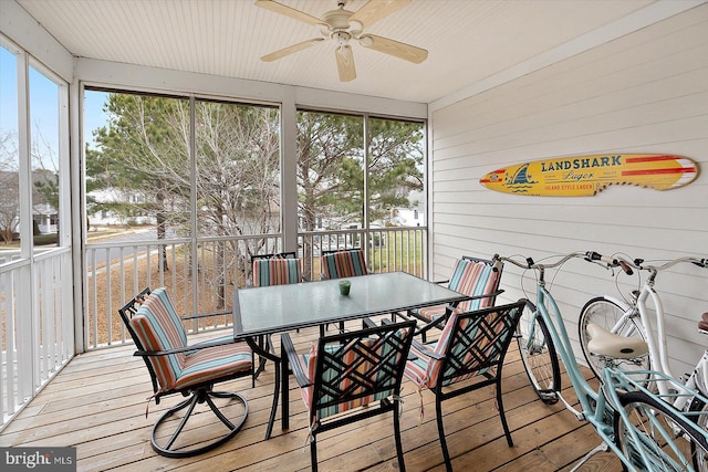 sunroom / solarium featuring ceiling fan