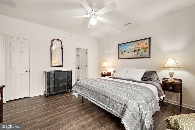 bedroom with dark hardwood / wood-style floors and ceiling fan