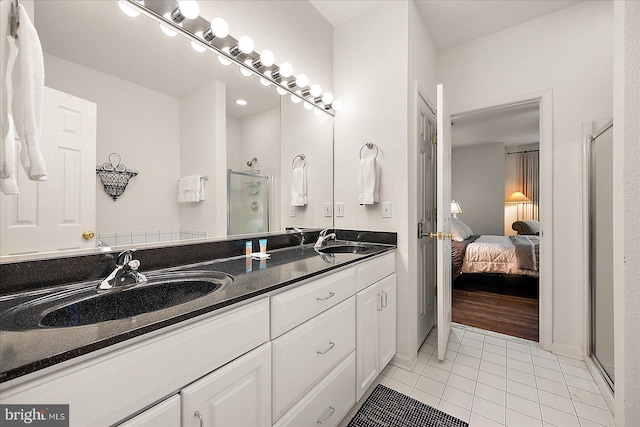 bathroom featuring vanity, tile patterned floors, and a shower with shower door