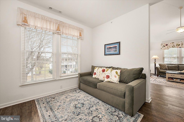 living room featuring ceiling fan and dark hardwood / wood-style floors