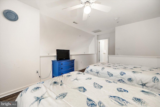 bedroom featuring hardwood / wood-style floors, vaulted ceiling, and ceiling fan