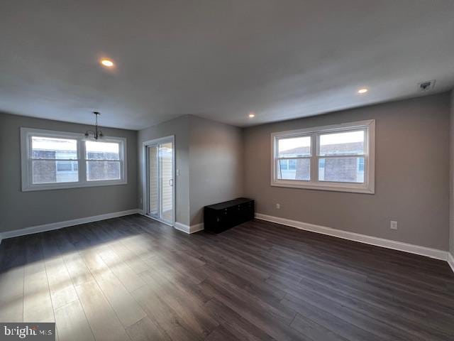 unfurnished living room with dark hardwood / wood-style floors