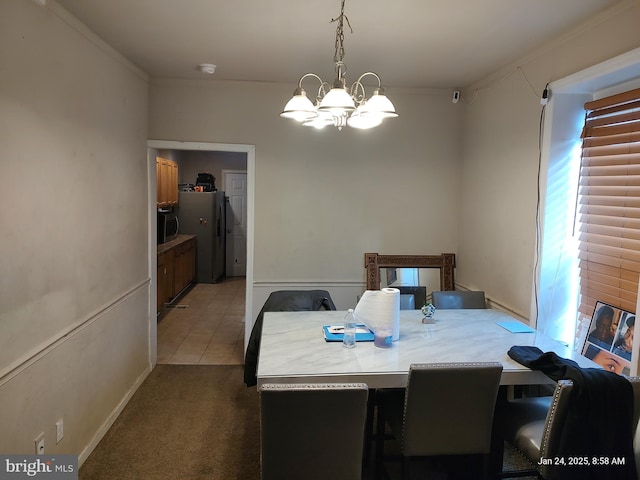 tiled dining room with a notable chandelier