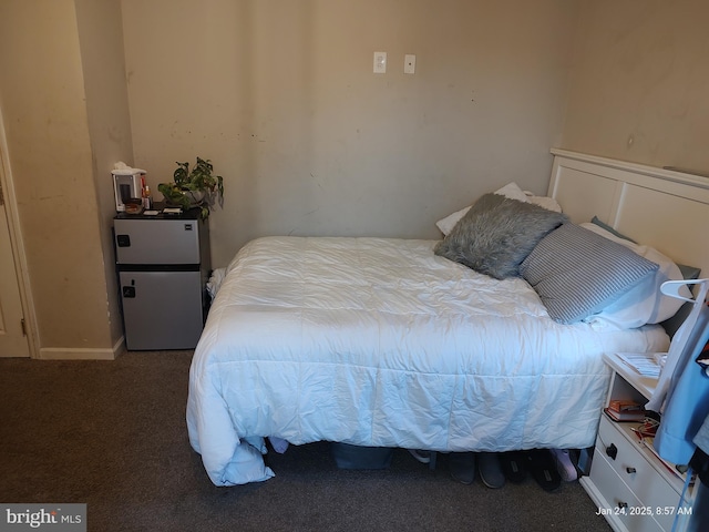 carpeted bedroom featuring refrigerator