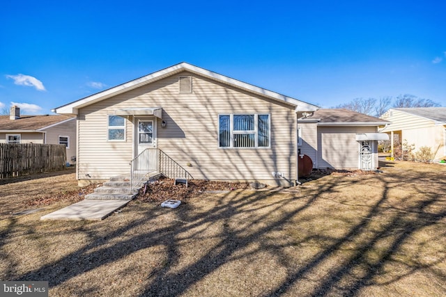 rear view of property with fence