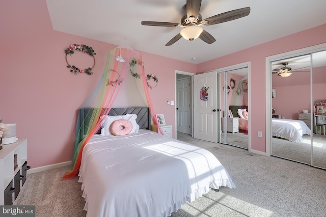 bedroom with multiple closets, light colored carpet, and ceiling fan