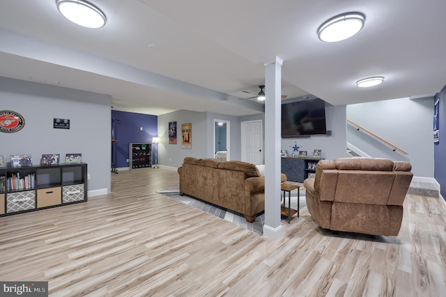 living room featuring ceiling fan and light hardwood / wood-style floors