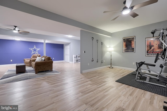 exercise area with ceiling fan and light hardwood / wood-style floors