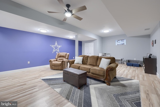 living room with wood-type flooring and ceiling fan