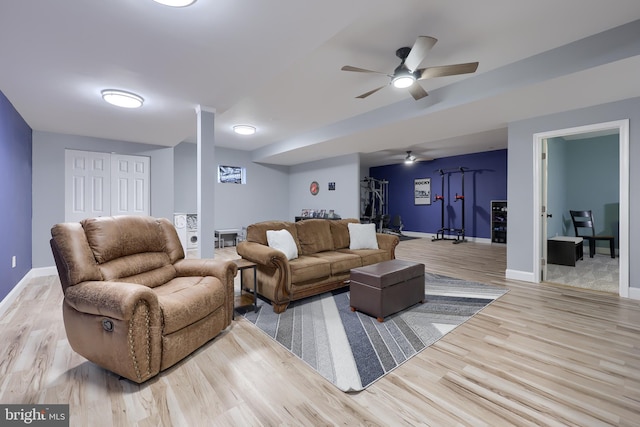 living room featuring ceiling fan and light hardwood / wood-style flooring