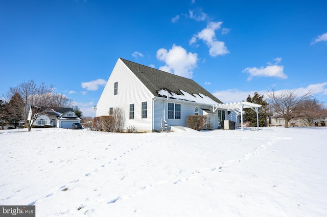 snow covered property featuring a pergola