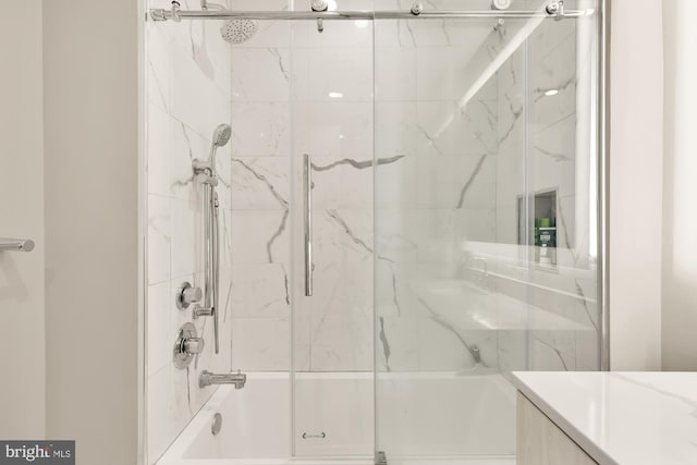 bathroom featuring shower / bath combination with glass door