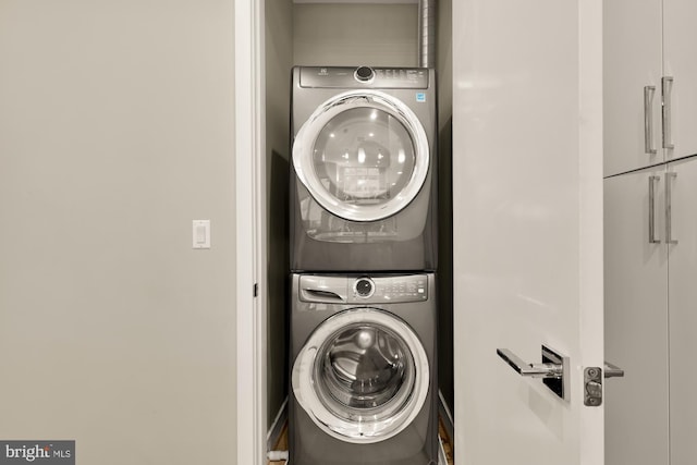 clothes washing area with stacked washer / drying machine