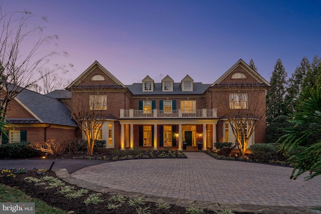 view of front of property featuring a porch and a balcony