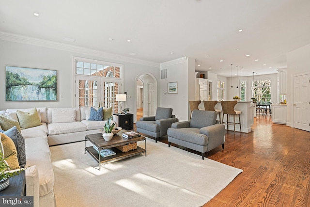 living room with ornamental molding and light hardwood / wood-style flooring