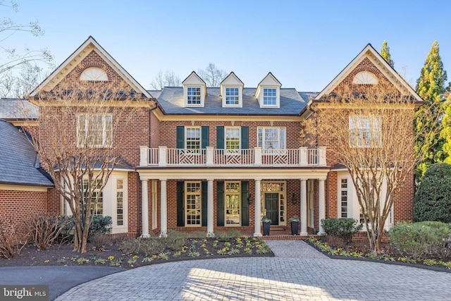 view of front of home with a balcony and covered porch