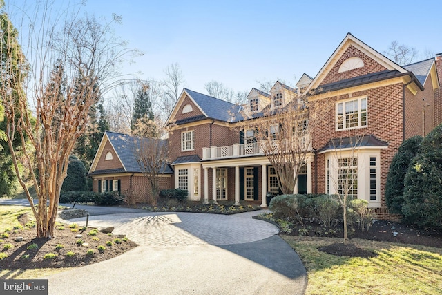 view of front of property featuring a balcony and covered porch