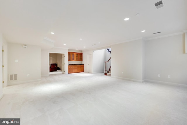 basement with light colored carpet and ornamental molding