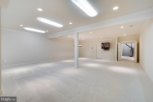 basement featuring ornamental molding and light colored carpet