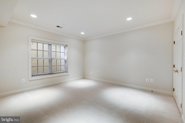 unfurnished room with ornamental molding and light carpet