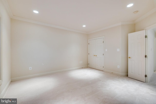 unfurnished room featuring light carpet and ornamental molding