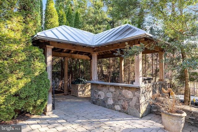 view of patio with a gazebo and an outdoor bar