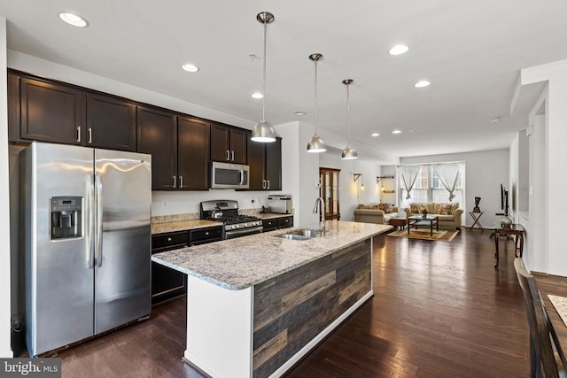 1324 Ray Ln, Glen Burnie, MD 21061 - kitchen featuring dark wood-style flooring, appliances with stainless steel finishes, dark brown cabinets, a sink, and open floor plan