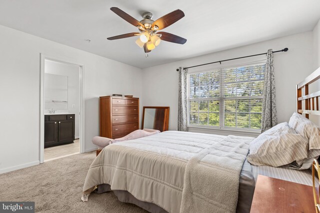 1324 Ray Ln, Glen Burnie, MD 21061 - bedroom featuring a sink, light carpet, baseboards, connected bathroom, and a ceiling fan