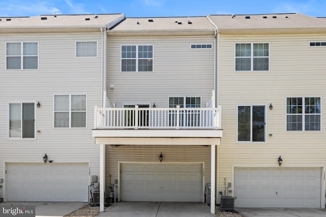 1324 Ray Ln, Glen Burnie, MD 21061 - back of property featuring an attached garage, central AC unit, and a balcony