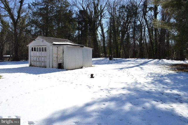 exterior space with a garage and an outbuilding