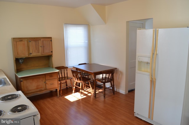 kitchen with hardwood / wood-style floors and white appliances