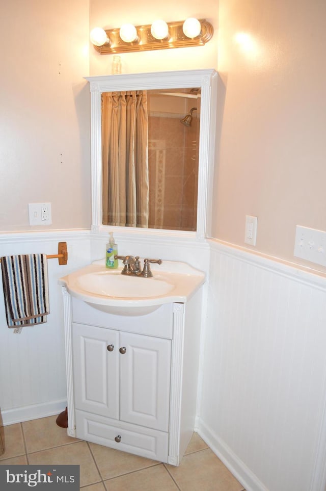 bathroom featuring vanity, tile patterned floors, and a shower