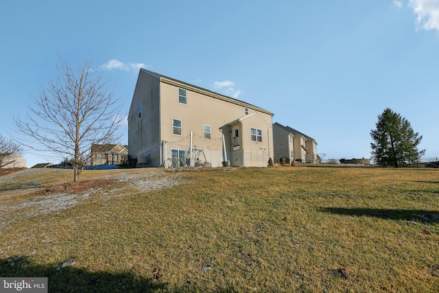 rear view of house with a yard