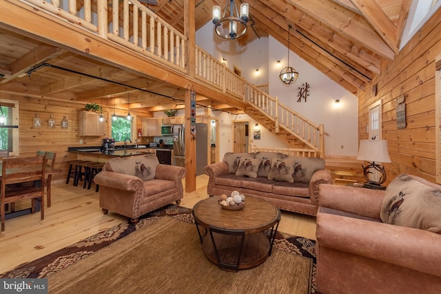 35 Blue Mountain Vw, Mc Henry, MD 21541 - living area with light wood finished floors, plenty of natural light, wooden walls, and an inviting chandelier