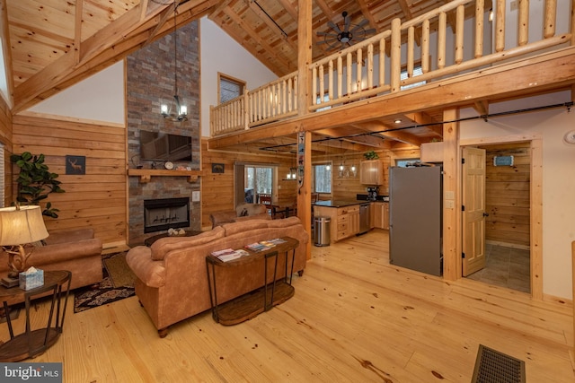 35 Blue Mountain Vw, Mc Henry, MD 21541 - living room featuring high vaulted ceiling, wood walls, and light wood-style flooring