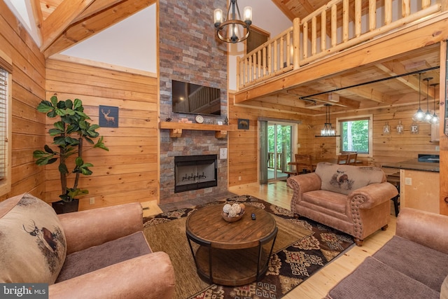 35 Blue Mountain Vw, Mc Henry, MD 21541 - living room with an inviting chandelier, wood finished floors, wooden walls, and a fireplace