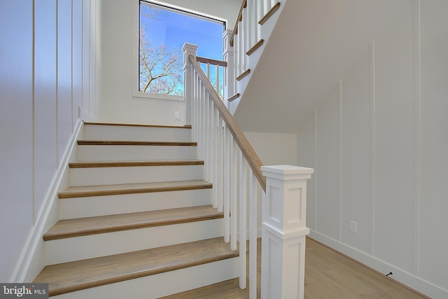 stairs featuring hardwood / wood-style floors