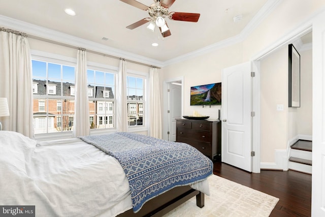 bedroom featuring ornamental molding, dark hardwood / wood-style floors, and ceiling fan