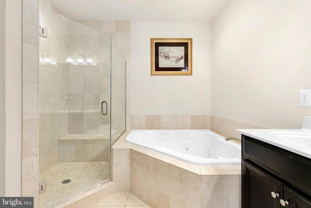 bathroom with independent shower and bath, vanity, and tile patterned flooring