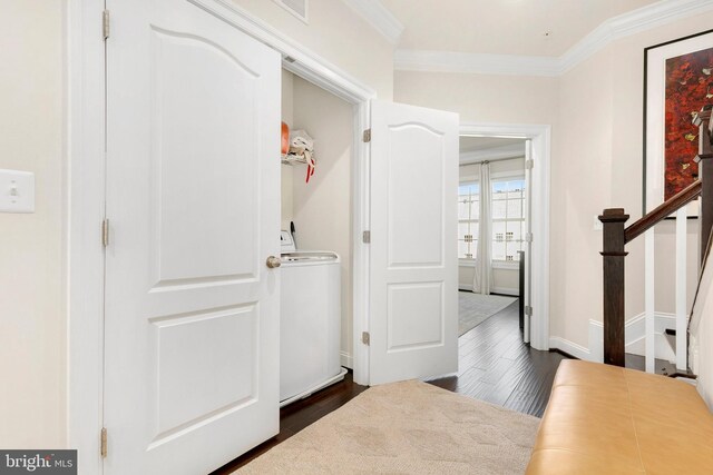 hall with dark hardwood / wood-style floors, ornamental molding, and washer / clothes dryer